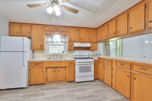 kitchen featuring ceiling fan, sink, tile countertops, and white appliances