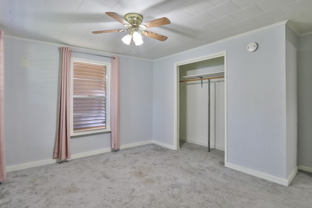 unfurnished bedroom featuring a closet, ceiling fan, ornamental molding, and light carpet