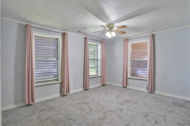 carpeted spare room featuring ornamental molding and ceiling fan