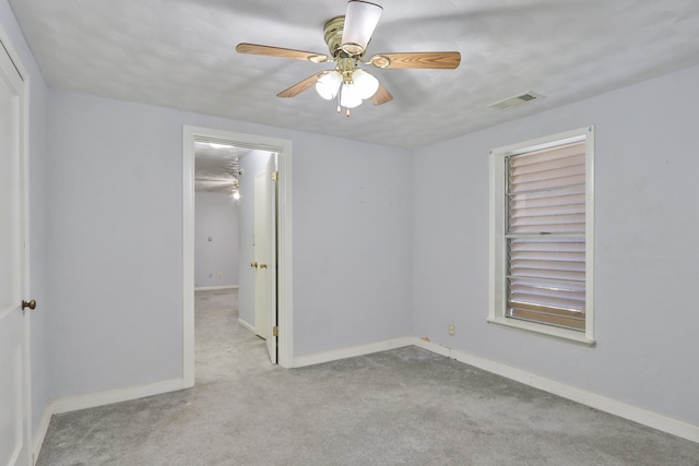 carpeted empty room featuring ceiling fan