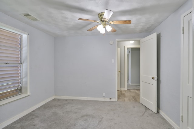 unfurnished room featuring ceiling fan and light colored carpet