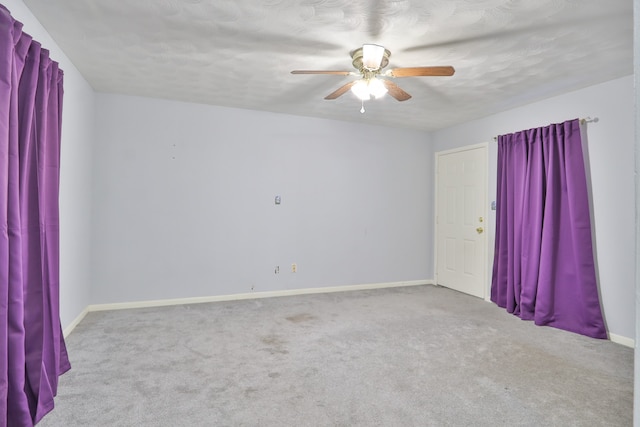 carpeted empty room featuring a textured ceiling and ceiling fan