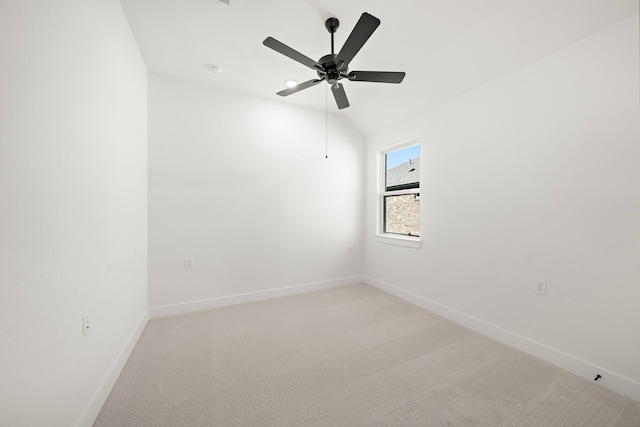 carpeted empty room featuring ceiling fan and lofted ceiling