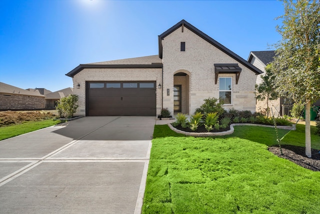 view of front facade featuring a garage and a front lawn