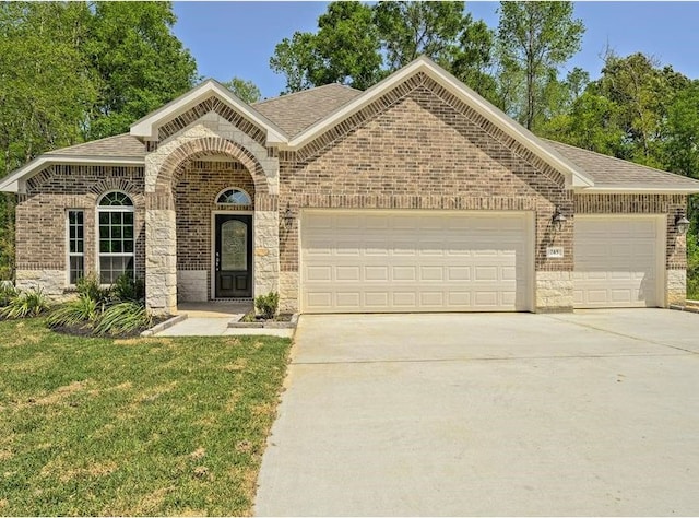 ranch-style house featuring a front lawn and a garage