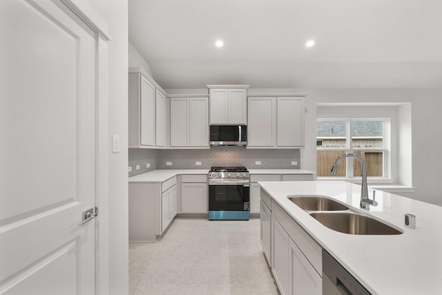 kitchen with stainless steel appliances, tasteful backsplash, and sink