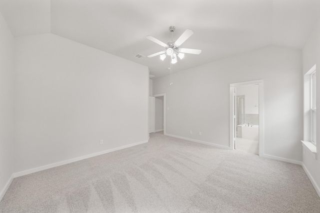 carpeted empty room with lofted ceiling and ceiling fan