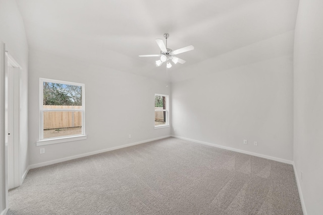 empty room featuring ceiling fan and light carpet