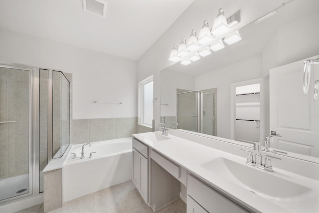 bathroom featuring tile patterned flooring, vanity, and shower with separate bathtub