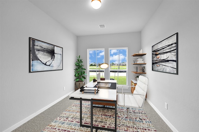 office with visible vents, baseboards, and carpet floors