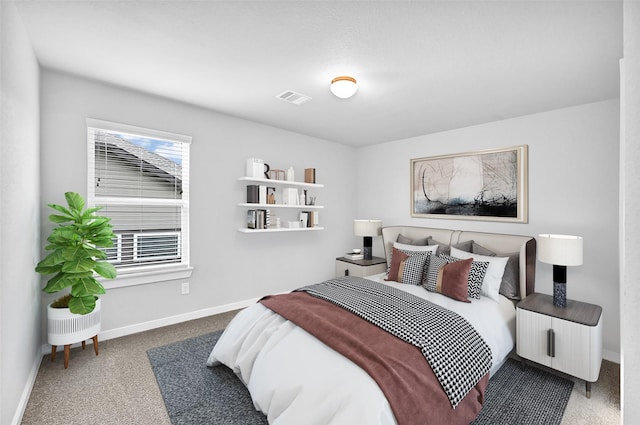 carpeted bedroom featuring visible vents and baseboards