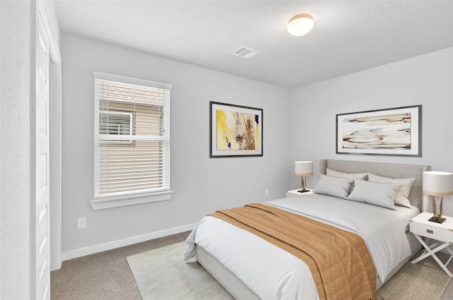 bedroom featuring visible vents, baseboards, and carpet floors