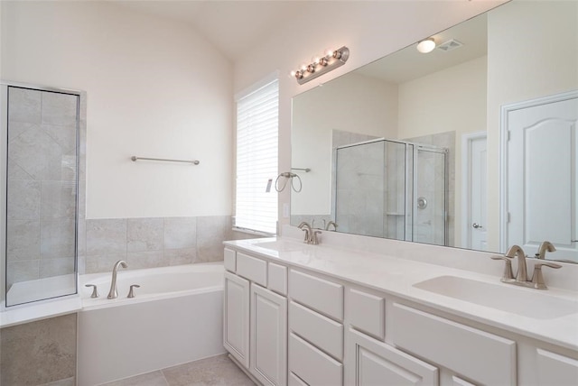 bathroom with vanity, tile patterned floors, vaulted ceiling, and plus walk in shower