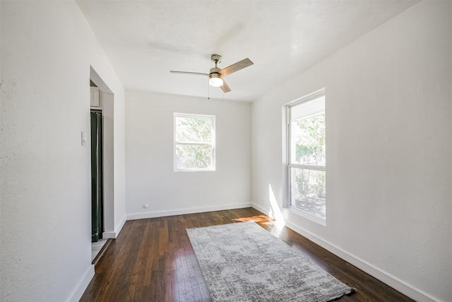 unfurnished bedroom featuring dark wood-type flooring and ceiling fan