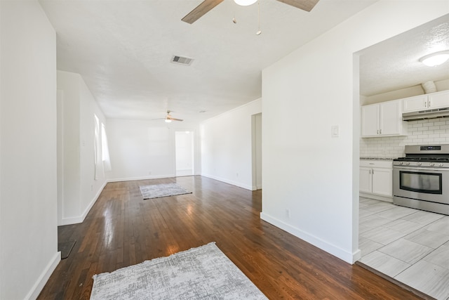 unfurnished living room featuring a textured ceiling, light hardwood / wood-style floors, and ceiling fan