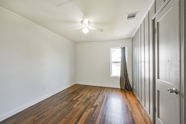 unfurnished room featuring crown molding, dark hardwood / wood-style floors, and ceiling fan