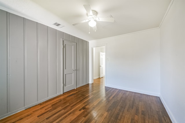 unfurnished bedroom featuring ceiling fan, crown molding, and dark hardwood / wood-style floors