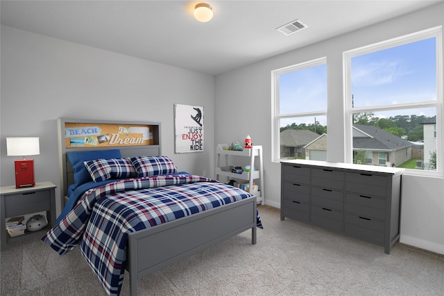 bedroom featuring light carpet