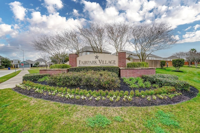 community / neighborhood sign with a yard, fence, and a residential view