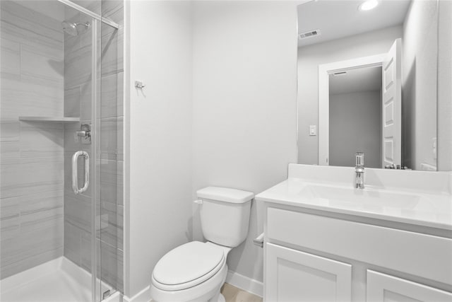 full bathroom with toilet, visible vents, vanity, baseboards, and a shower stall