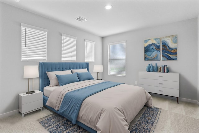 bedroom with baseboards, visible vents, and light colored carpet