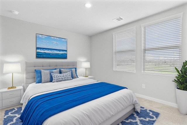 bedroom featuring light carpet, visible vents, and baseboards