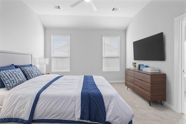 bedroom with light carpet, vaulted ceiling, visible vents, and baseboards