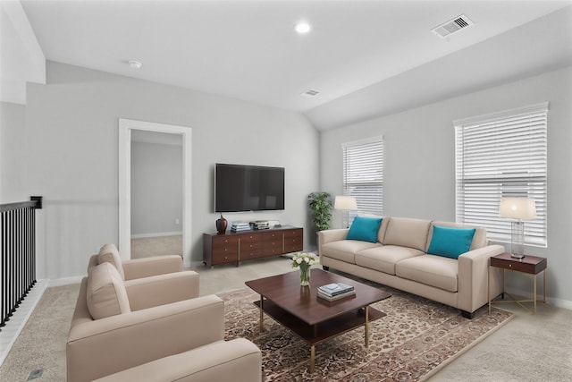 living area featuring visible vents, vaulted ceiling, and baseboards