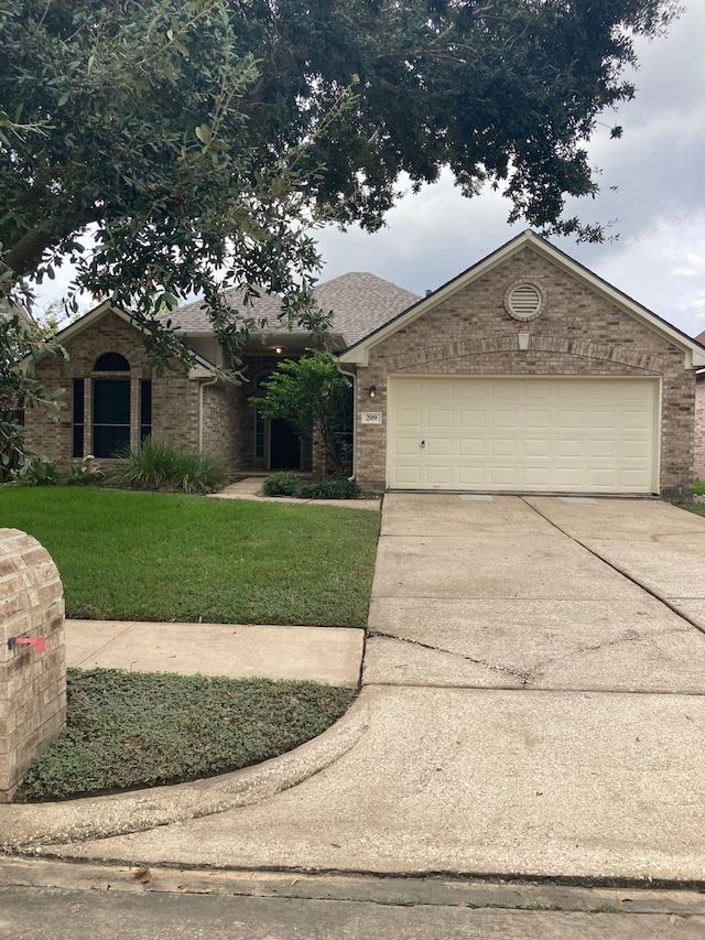 view of front of home with a garage and a front yard