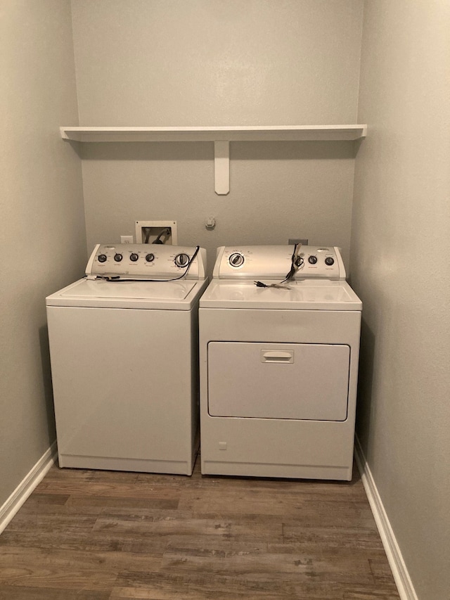 laundry room with dark wood-type flooring and washing machine and dryer