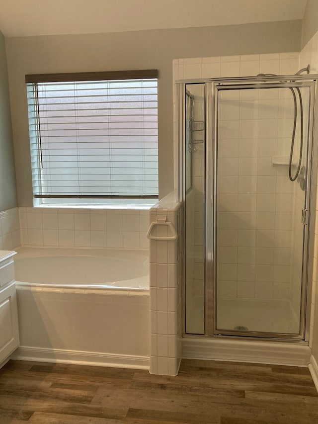 bathroom with vanity, plus walk in shower, and hardwood / wood-style flooring