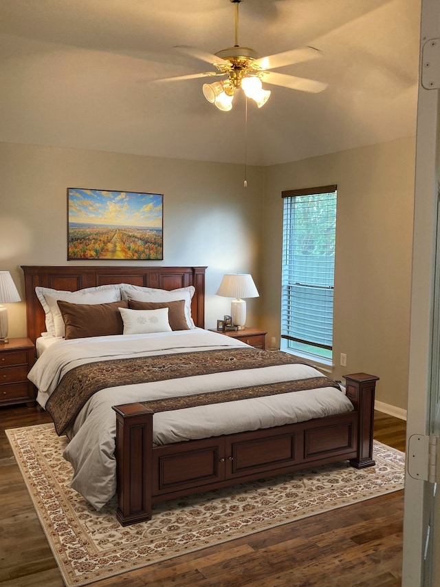 bedroom with ceiling fan and dark wood-type flooring