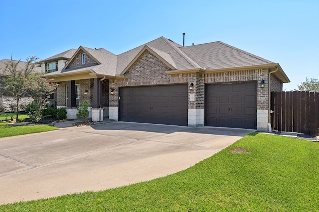 view of front of home featuring a garage and a front lawn