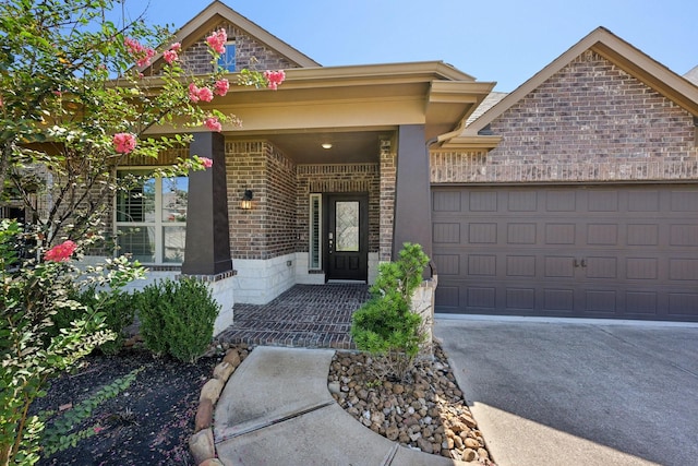 doorway to property with a garage