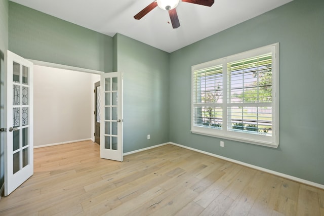 empty room featuring french doors, ceiling fan, and light hardwood / wood-style floors