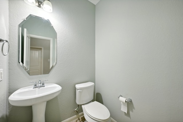 bathroom with sink and toilet