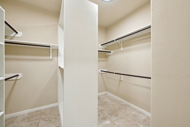 spacious closet featuring light tile patterned floors