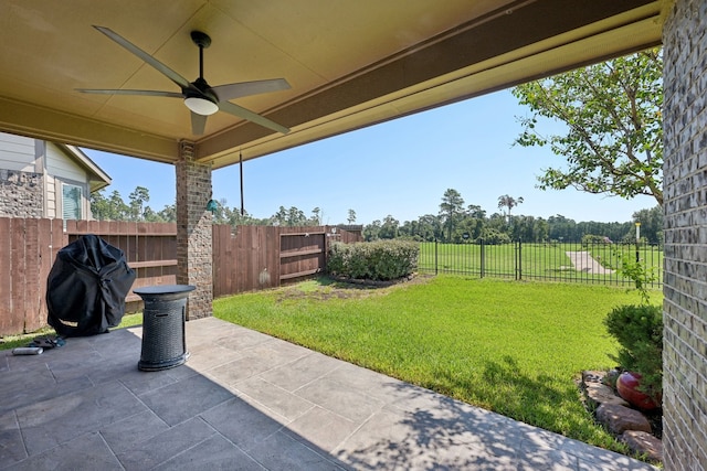 view of yard with ceiling fan and a patio area