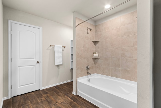 bathroom with tiled shower / bath combo and wood-type flooring