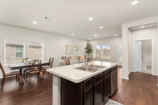 kitchen with dishwasher, dark hardwood / wood-style floors, sink, an island with sink, and dark brown cabinetry