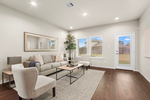 living room with plenty of natural light and dark hardwood / wood-style floors