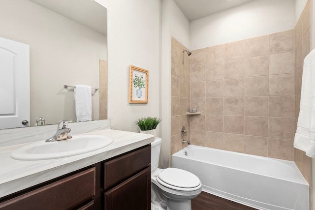 full bathroom featuring toilet, tiled shower / bath, wood-type flooring, and vanity