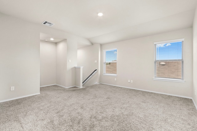 unfurnished room with light carpet and plenty of natural light