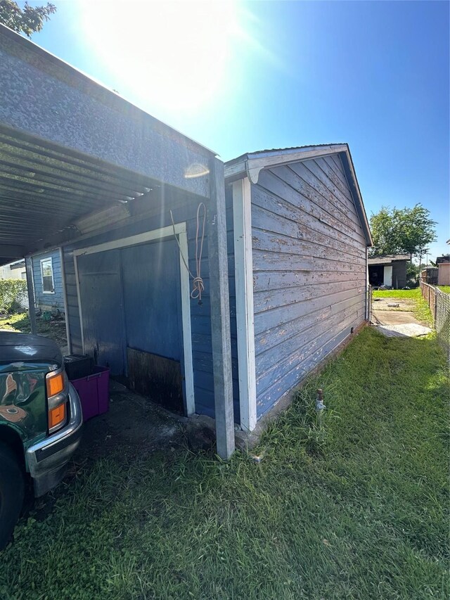 view of side of home with a yard