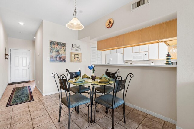 12800 Melville Dr Unit A313, Montgomery, TX 77356 - dining room featuring light tile patterned floors, baseboards, and visible vents