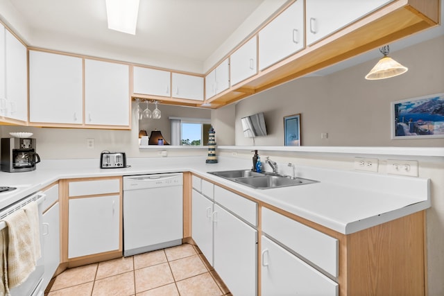 kitchen featuring white appliances, light tile patterned floors, decorative light fixtures, sink, and white cabinets