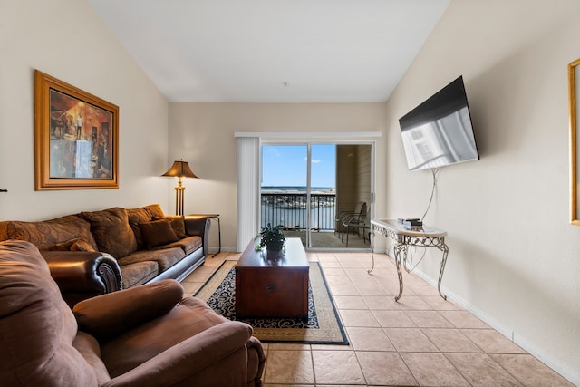 living room with vaulted ceiling and light tile patterned floors