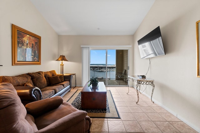 12800 Melville Dr Unit A313, Montgomery, TX 77356 - living area featuring baseboards, vaulted ceiling, and light tile patterned floors