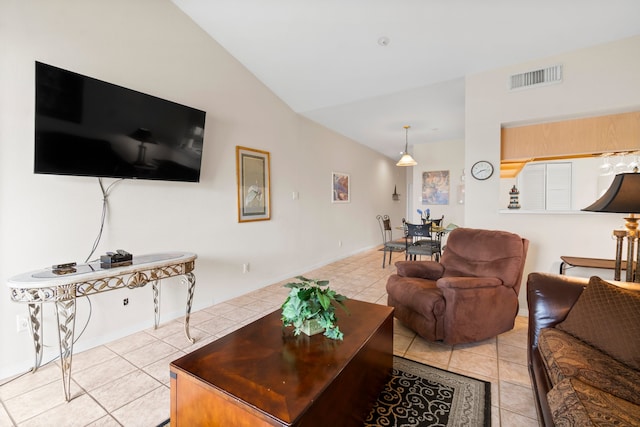 living room featuring lofted ceiling and light tile patterned floors