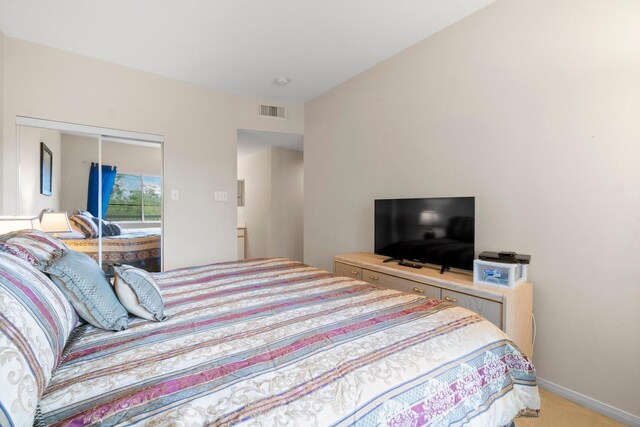 12800 Melville Dr Unit A313, Montgomery, TX 77356 - bedroom featuring light carpet, baseboards, visible vents, and a closet